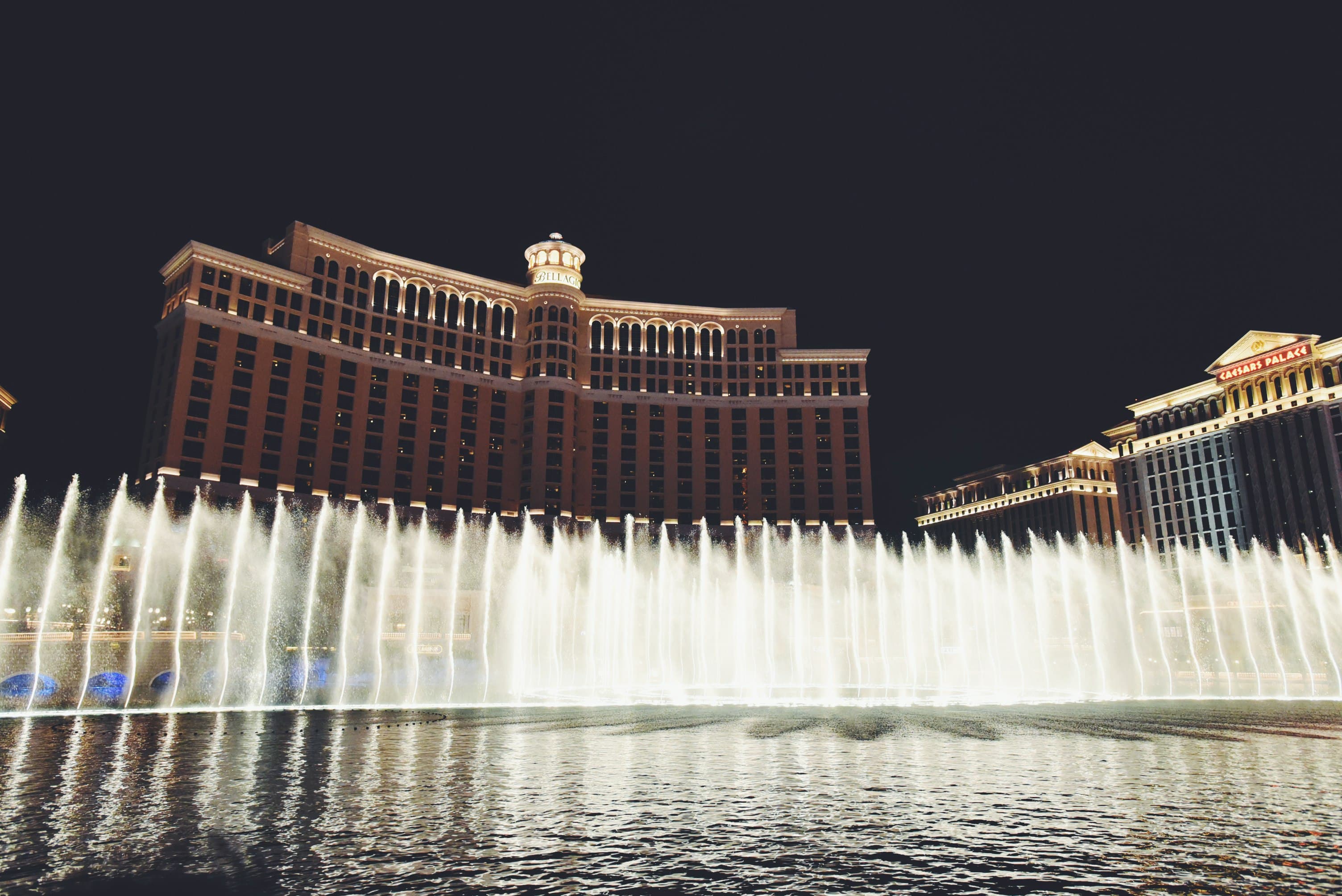 The Bellagio fountains lit up against the night sky on the Las Vegas Strip