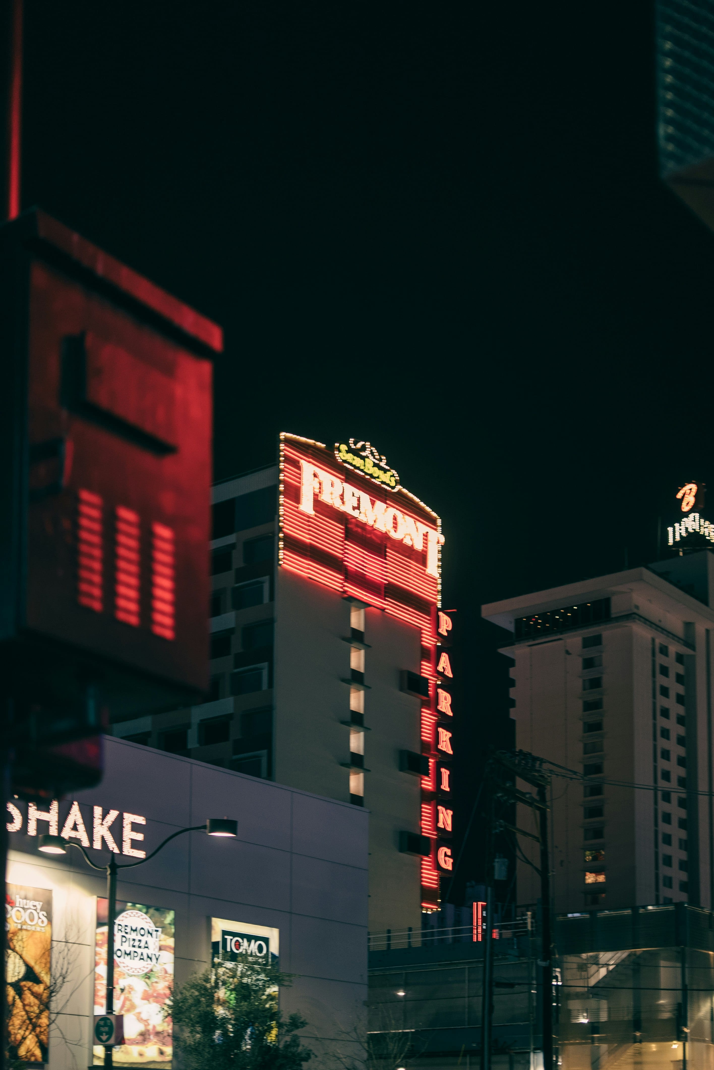 Fremont Street facades and the Fremont Hotel sign lit up after dark