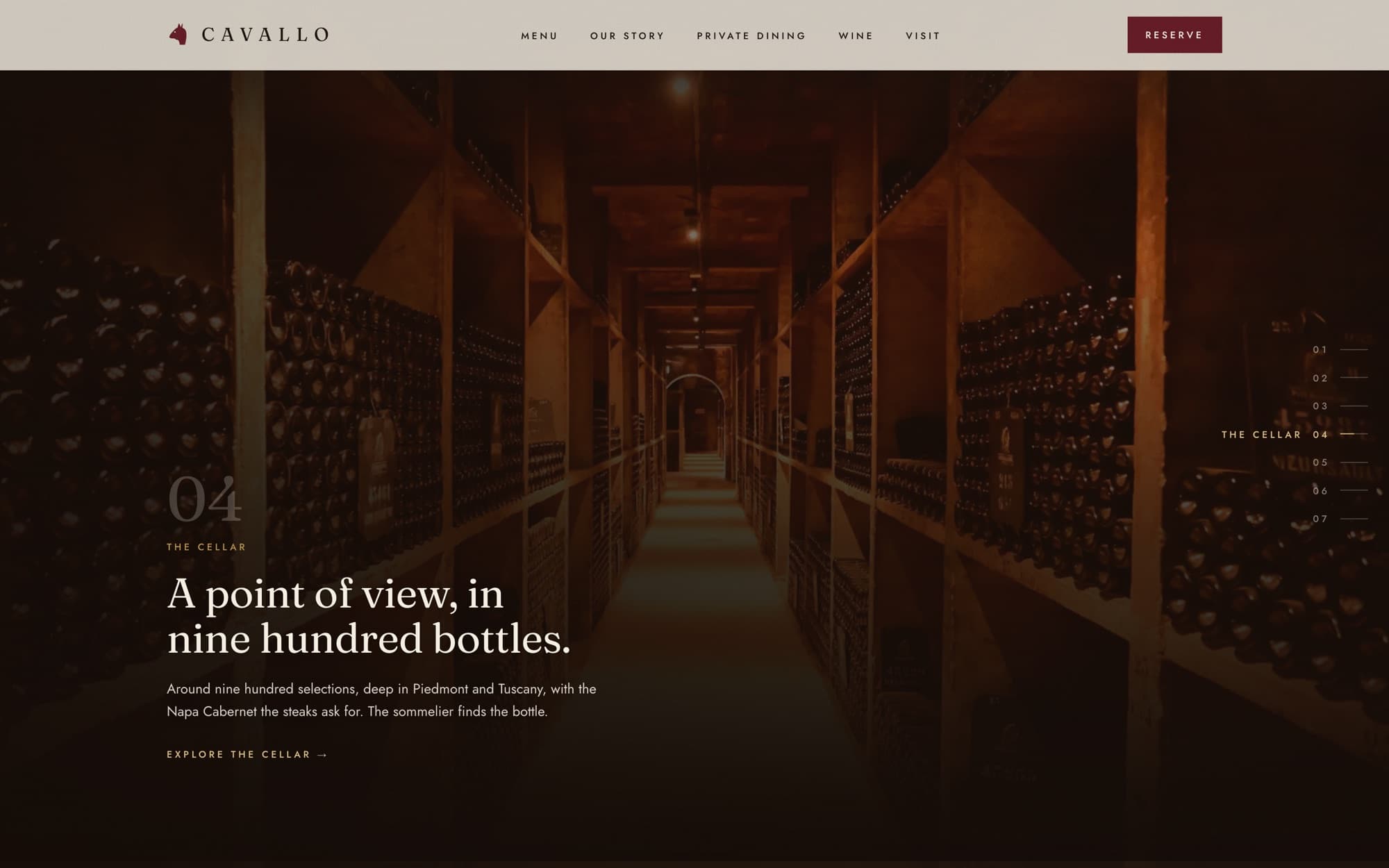 A warm-lit wine-cellar corridor lined with racked bottles.