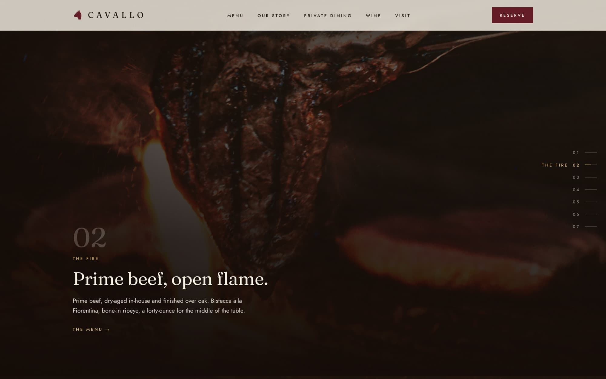 A thick steak flaring over a live-fire grill.